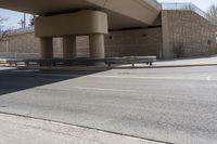 the shadow on the side of an empty road on a sunny day with no clouds