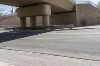 the shadow on the side of an empty road on a sunny day with no clouds