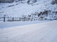 an empty road and snow covered mountains near the tracks in the distance are train tracks
