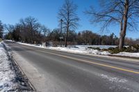 a road is empty in winter and the road is cleared off from snow and ice