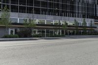 an empty road on a city street, with tall buildings behind it with no people