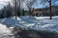 an empty road with the shadows on the snowbank on either side of the street