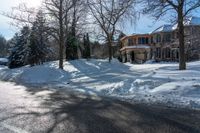 an empty road with the shadows on the snowbank on either side of the street