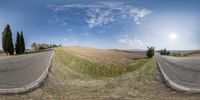 a split screen photo showing two different views of an empty road and field with trees on both sides