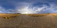 an empty road with a sky in the background as if there's a fisheye lens