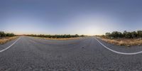 the road is straight and empty and looks empty in this 360 - view photo,