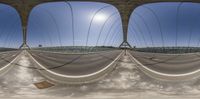 several images of an empty road taken from the street level perspective mirror of some bridge