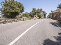 a car driving down the middle of a road with no cars on it's way