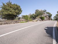 a car driving down the middle of a road with no cars on it's way