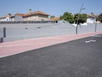 the empty roadway is painted gray in color and bricks on the walls are lined with black tiles