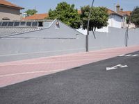 the empty roadway is painted gray in color and bricks on the walls are lined with black tiles