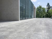 a empty room with a concrete wall and a red fire hydrant in it, as the sun shines on the stone floor