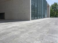 a empty room with a concrete wall and a red fire hydrant in it, as the sun shines on the stone floor