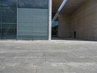 a empty room with a concrete wall and a red fire hydrant in it, as the sun shines on the stone floor