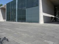 a empty room with a concrete wall and a red fire hydrant in it, as the sun shines on the stone floor