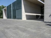 a empty room with a concrete wall and a red fire hydrant in it, as the sun shines on the stone floor