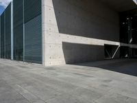 a empty room with a concrete wall and a red fire hydrant in it, as the sun shines on the stone floor