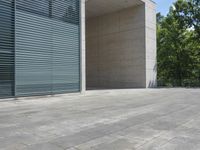 a empty room with a concrete wall and a red fire hydrant in it, as the sun shines on the stone floor