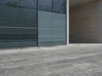 a empty room with a concrete wall and a red fire hydrant in it, as the sun shines on the stone floor