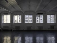 a room that is empty with a window on the side and the ceiling of the room behind it