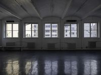 a room that is empty with a window on the side and the ceiling of the room behind it