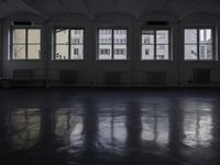 a room that is empty with a window on the side and the ceiling of the room behind it