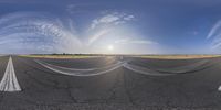 three different views of an empty runway on the side of a road at sunset with a bright blue sky