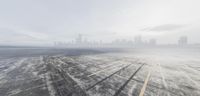 the runway is completely empty in this image by the cityscape in the background