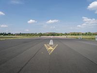 an empty runway with a large sign painted in the middle of it's pavement