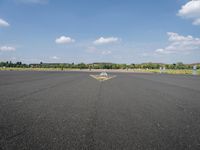 an empty runway with a large sign painted in the middle of it's pavement