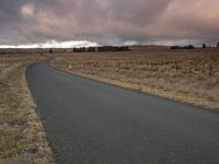 this is an empty road in a rural area at sunset near the plains of iceland