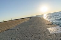 the sea front is empty and empty on a sunny day at sunset, with some sun reflections