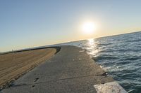 the sea front is empty and empty on a sunny day at sunset, with some sun reflections