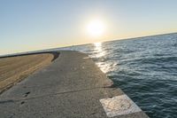 the sea front is empty and empty on a sunny day at sunset, with some sun reflections