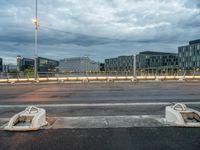 a couple of empty seats sitting on the side of a road in front of a building