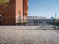 the large building is made of concrete and has metal railings around it, which are made of brick