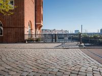 the large building is made of concrete and has metal railings around it, which are made of brick