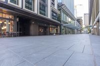 empty sidewalk in front of office buildings in the city of london, england at dusk