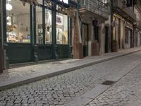 the sidewalk is empty of any vehicles, and the storefronts are glassed