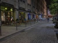 the sidewalk is empty of any vehicles, and the storefronts are glassed