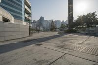 the sidewalk is empty with water and buildings in the background in hong kong, malaysia
