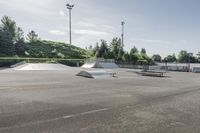 the skate park is empty and ready for people to ride on it, while others look on