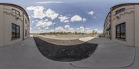 an empty skateboard park with clouds in the sky above the rinks with people on it