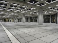 an empty space is shown with square tiles on the ground and several floors on both sides