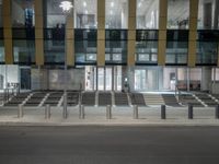 a street lined with multiple sets of benches in front of a building that says the station is empty