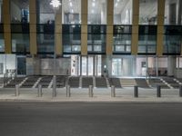 a street lined with multiple sets of benches in front of a building that says the station is empty