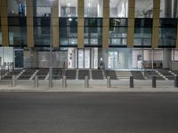 a street lined with multiple sets of benches in front of a building that says the station is empty