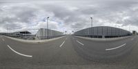 a few buildings that are on an empty street from which to drive down it is an airport