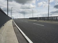 the empty street near an airport is surrounded by large billboards that read ber