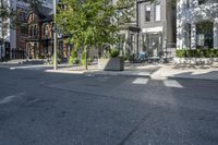 an empty street is full of apartment buildings on a sunny day in toronto, ontario